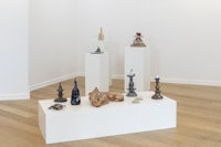 a white room with several sculptures on display