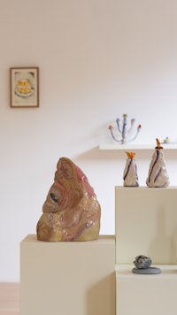 a room with several vases and sculptures on display